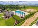 Aerial view of community pool area with palm trees, a playground and clubhouse at 892 Grandin St, Davenport, FL 33837