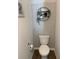 Cozy powder room with decorative wallpaper, floating shelves with plant decor, and modern fixtures at 892 Grandin St, Davenport, FL 33837