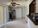 Open-concept living area with a stone fireplace, tile floors, and easy access to the kitchen and outdoor space at 925 Derbyshire Dr, Kissimmee, FL 34758