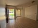 Bright living room with tile floors, neutral walls, and a view of the front yard through the large window at 925 Derbyshire Dr, Kissimmee, FL 34758