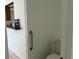 Convenient powder room near the kitchen area, featuring a toilet and a grab bar for accessibility and safety at 925 Derbyshire Dr, Kissimmee, FL 34758