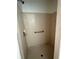 Neutral shower featuring tiled walls, shower head, and a safety bar at 925 Derbyshire Dr, Kissimmee, FL 34758
