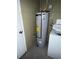 Water heater next to the washing machine hookup at 925 Derbyshire Dr, Kissimmee, FL 34758