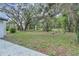 Large, private backyard featuring mature trees and a lush lawn at 9905 Nicoma Ln, Orlando, FL 32817