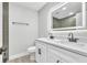 Bright bathroom featuring a double sink vanity with backlit mirror at 9905 Nicoma Ln, Orlando, FL 32817