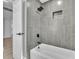 Bathroom with a modern shower head and faucet, as well as tiled walls at 9905 Nicoma Ln, Orlando, FL 32817