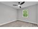 A bright bedroom features a ceiling fan, window, and neutral decor at 9905 Nicoma Ln, Orlando, FL 32817
