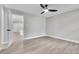 Bedroom with ceiling fan, neutral walls, and views into the living space at 9905 Nicoma Ln, Orlando, FL 32817