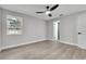 Bedroom with ceiling fan, window, and adjacent bathroom access at 9905 Nicoma Ln, Orlando, FL 32817