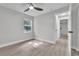 Bright bedroom with new floors, ceiling fan, and a window offering natural light at 9905 Nicoma Ln, Orlando, FL 32817