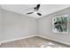 Cozy bedroom with a ceiling fan and a window offering natural light at 9905 Nicoma Ln, Orlando, FL 32817