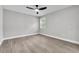 A bright bedroom features a ceiling fan, window, and neutral decor at 9905 Nicoma Ln, Orlando, FL 32817