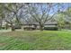 Well-maintained single-story home featuring a two-car garage, tidy front lawn, and mature trees at 9905 Nicoma Ln, Orlando, FL 32817