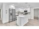 Well-lit kitchen featuring stainless steel appliances, ample white cabinetry, and a convenient island at 9905 Nicoma Ln, Orlando, FL 32817