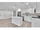 Modern kitchen with stainless steel appliances, white cabinetry, and a central island at 9905 Nicoma Ln, Orlando, FL 32817