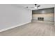Spacious living room with a decorative fireplace, mantle, and light wood-look flooring at 9905 Nicoma Ln, Orlando, FL 32817