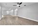 Spacious and neutral living area with modern ceiling fan and light wood-look flooring throughout at 9905 Nicoma Ln, Orlando, FL 32817