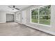 An airy living room showcasing light flooring, ample sunlight, and a view of the outdoors at 9905 Nicoma Ln, Orlando, FL 32817