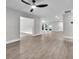 Bright living room showcasing light wood-look flooring, an open floorplan, and views to the exterior at 9905 Nicoma Ln, Orlando, FL 32817