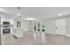 Bright, open concept living area featuring stylish island, sleek floors, and abundant natural light at 9905 Nicoma Ln, Orlando, FL 32817