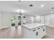 Bright, open living room with stylish lighting, lots of windows and a modern kitchen island at 9905 Nicoma Ln, Orlando, FL 32817