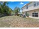 A view of the backyard with a partially covered patio, privacy fence, and some trees and plantings at 1526 Ferendina Dr, Deltona, FL 32725