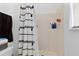 Bright bathroom showcasing a stand-up shower with a decorative black and white curtain and toiletries shelf at 1526 Ferendina Dr, Deltona, FL 32725