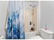 Cozy bathroom features a tub with shower and blue patterned curtain for enhanced appeal and privacy at 1526 Ferendina Dr, Deltona, FL 32725