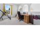 Bright room featuring arched windows, a desk, and exercise equipment; perfect for a versatile home office or guest space at 1526 Ferendina Dr, Deltona, FL 32725