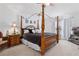 Primary bedroom with four-poster bed, side tables, and ample natural light from nearby windows at 1526 Ferendina Dr, Deltona, FL 32725