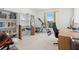 Bedroom featuring carpet, a large window and a white bookshelf with home gym equipment at 1526 Ferendina Dr, Deltona, FL 32725