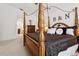 Comfortable bedroom features a dark wood four-poster bed and a nearby dresser at 1526 Ferendina Dr, Deltona, FL 32725