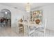 Bright dining room features tiled floors, elegant white marble table and seating for six underneath a crystal chandelier at 1526 Ferendina Dr, Deltona, FL 32725