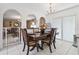 Dining room with tiled floor and glass sliding doors features a classic wood table with seating for four at 1526 Ferendina Dr, Deltona, FL 32725