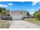 An attractive two-story home with an attached two car garage, arched window, and a well maintained lawn at 1526 Ferendina Dr, Deltona, FL 32725