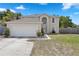 An attractive two-story home with an attached two car garage, arched window, and a well maintained lawn at 1526 Ferendina Dr, Deltona, FL 32725