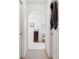 Hallway leads to a bathroom with a dark wood vanity and an arched doorway at 1526 Ferendina Dr, Deltona, FL 32725