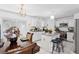 Bright kitchen featuring granite countertops, white cabinets, and stainless steel appliances at 1526 Ferendina Dr, Deltona, FL 32725