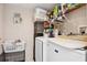 A full laundry room with appliances, storage rack, and a pet cage underneath at 1526 Ferendina Dr, Deltona, FL 32725