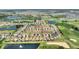 Picturesque aerial view of the community featuring stunning water views, golf course, and well-maintained landscaping at 1064 Quaker Ridge Ln, Davenport, FL 33896