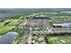 Stunning aerial view of a townhome community boasting a pool, golf course, and tranquil water features at 1064 Quaker Ridge Ln, Davenport, FL 33896