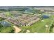 Lovely community aerial view with water features and a lush green golf course at 1064 Quaker Ridge Ln, Davenport, FL 33896