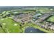 Scenic aerial view of the townhome community highlighting water features and the surrounding golf course at 1064 Quaker Ridge Ln, Davenport, FL 33896