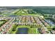 Aerial view of the community featuring the townhomes, nearby golf course, and serene water features at 1064 Quaker Ridge Ln, Davenport, FL 33896
