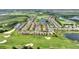 Overhead view of the townhome community showing the golf course and pool at 1064 Quaker Ridge Ln, Davenport, FL 33896