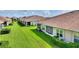 Scenic backyard featuring lush lawn, well-maintained hedges, and inviting screened-in porches at 1064 Quaker Ridge Ln, Davenport, FL 33896