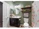 Cozy bathroom featuring vanity, a commode, and a tub-shower with flamingo-themed shower curtain at 1064 Quaker Ridge Ln, Davenport, FL 33896