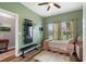 Bedroom featuring green walls, wood-look floors, and a wall-mounted workout station at 1064 Quaker Ridge Ln, Davenport, FL 33896