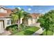 Charming home with manicured landscaping, mature palms, and brick-paved driveway at 1064 Quaker Ridge Ln, Davenport, FL 33896