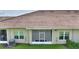 Back exterior view of a home featuring a screened-in porch and neat landscaping at 1064 Quaker Ridge Ln, Davenport, FL 33896
